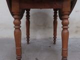 a small wooden table with two legs and a table top