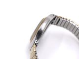 an image of a watch on a white surface with a white background