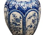a blue and white vase sitting on a white surface