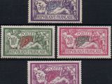 a group of four different colored stamps on a black surface
