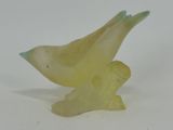 a yellow bird that is sitting on a white table