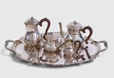a silver tray with a silver tea set on it