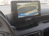 a car dashboard with a monitor and a steering wheel