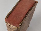an old book sitting on top of a white table