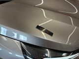 a close up of a car with a shiny hood