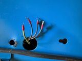 two wires that are connected to a blue wall