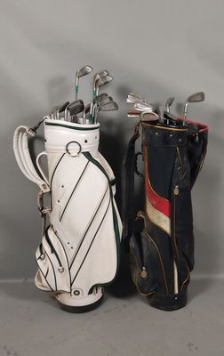 deux clubs de golf sont alignés l'un à côté de l'autre sur une surface grise