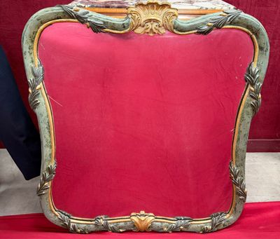 a red chair with a gold frame on a red table