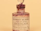 an old bottle of perfume sitting on top of a table