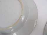 two plates that are sitting on a white table