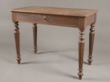 an old wooden table with a drawer on top of it