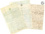 three old letters are sitting on top of a piece of paper