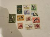 many different stamps on a table with a shadow of a person