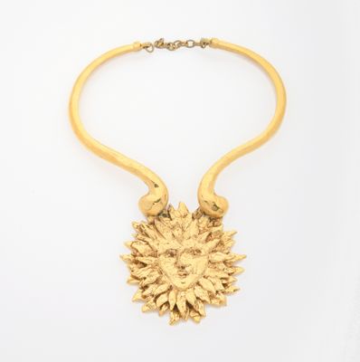 an image of a gold necklace with a sunflower on it