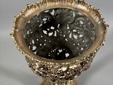 a gold vase that is sitting on a table