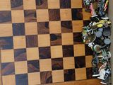 a wooden chess board in a box with a lot of pieces