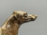a statue of a dog that is sitting on a table