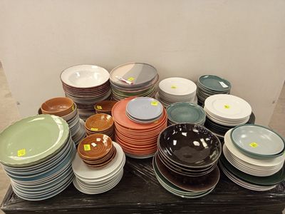 a lot of plates and bowls on the table