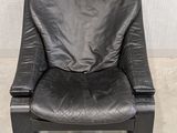 black leather reclining chair in a corner of a room