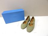 the shoes are on the table next to a blue box