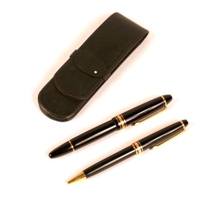 two pens and a pen case sitting next to each other on a white surface