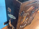 a black cabinet with a horse on top of it
