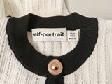 an image of a self portrait label on a sweater