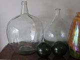 three glass vases sitting on a table next to each other