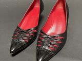 a pair of black and red shoes on a black surface