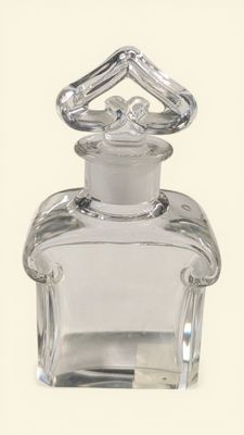 a clear glass bottle with a silver lid