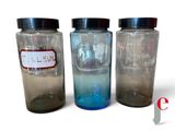 trois bocaux en verre contenant des liquides de couleurs différentes