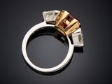 a close up of a ring with three stones on a black surface