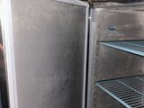 a refrigerator that is open in a room with shelves