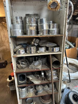 many pots and pans on a shelf in a room