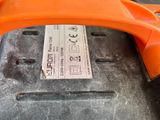 an orange phone sitting on top of a black suitcase