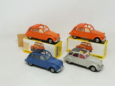 three small toy cars are sitting in a box on a white surface