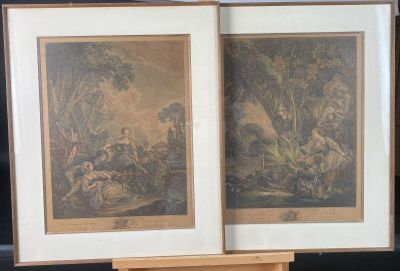 two framed pictures of a couple of animals on a table