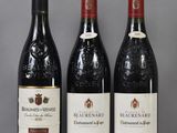 three bottles of wine are lined up on a table