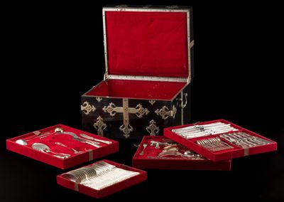 a red box with silverware in it on a black background
