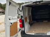 a white van with its doors open in a parking lot