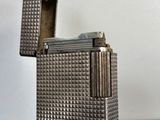 a silver lighter that is sitting on a table
