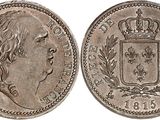a silver coin with a crown on top of it