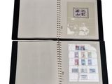 an open book with stamps on it sitting on top of a table