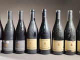 six bottles of wine are lined up in a row on a table
