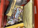 a red box filled with assorted items on the ground