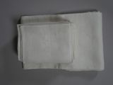 three white linen napkins on a table with a white background