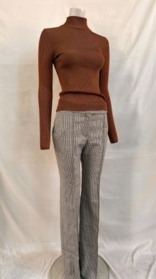 a picture of a mannequin wearing a turtle neck sweater and pants
