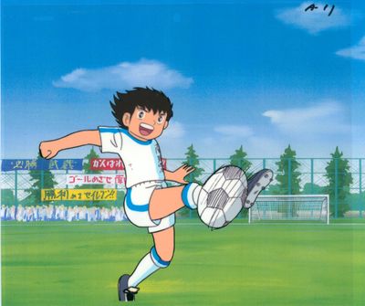 cartoon picture of a boy kicking a soccer ball on a soccer field
