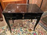 a small table with two drawers on it in a room