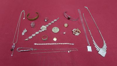 many different necklaces and bracelets laid out on a table